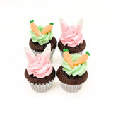 Mini cupcakes in green and pink buttercream frosting topped with carrots and bunny ears made of fondant by Sweetest Moments Singapore.