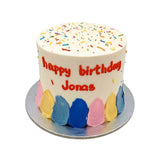 round cake with rainbow sprinkle on top