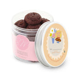 Jar of cookies with a pink label and a white lid featuring branding.